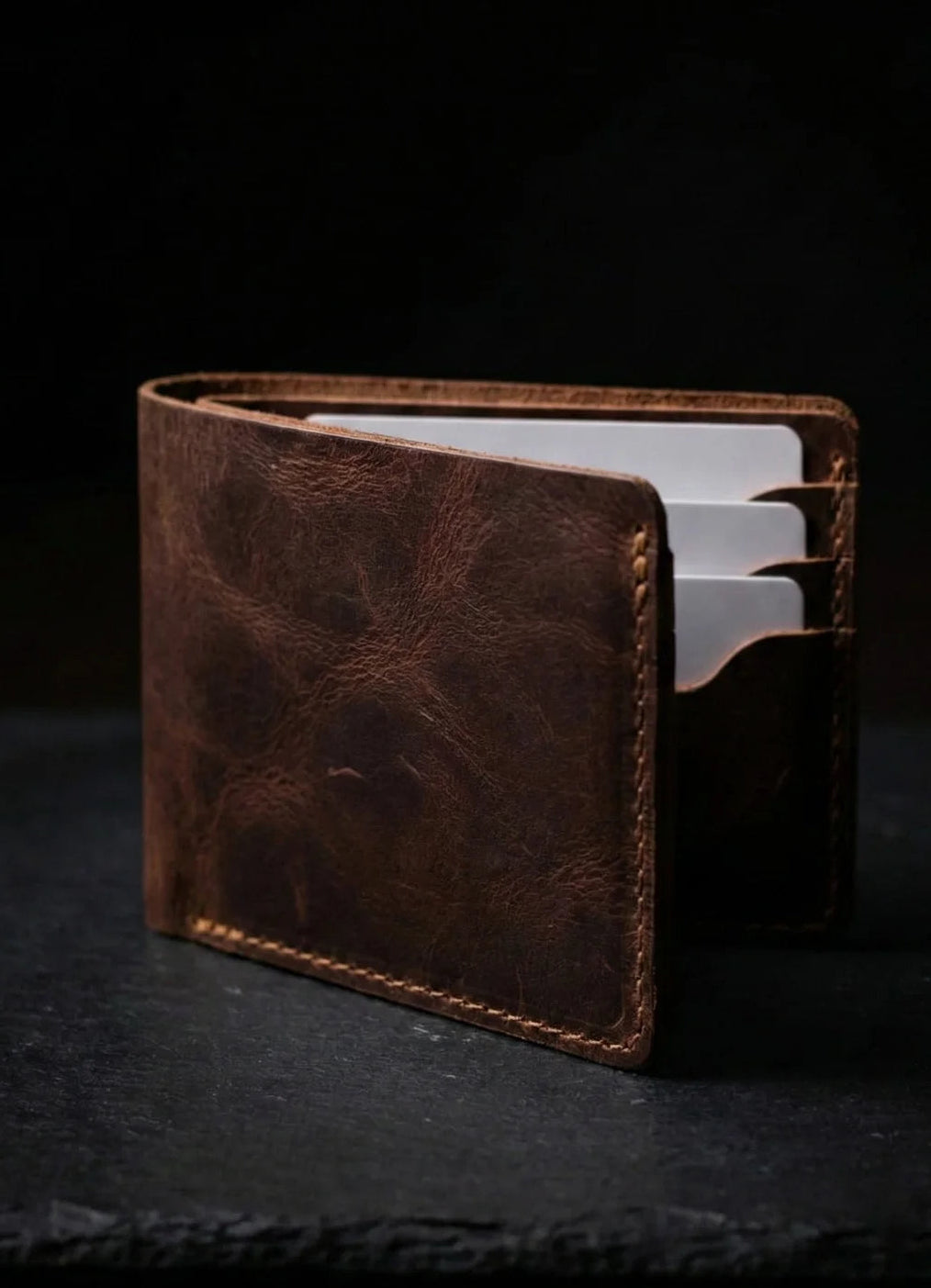 Brown leather wallet on a dark background